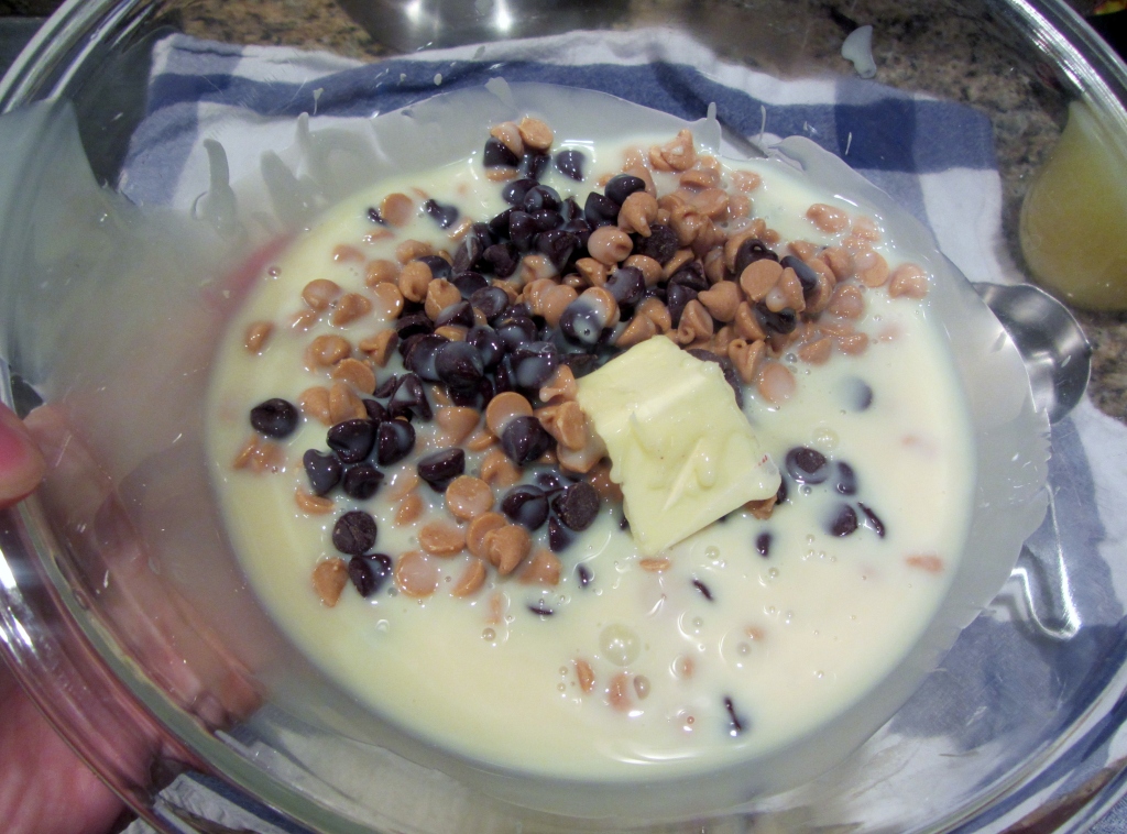 Add your chocolate chips, peanut butter chips, butter, and sweetened condensed milk in a large microwavable bowl.