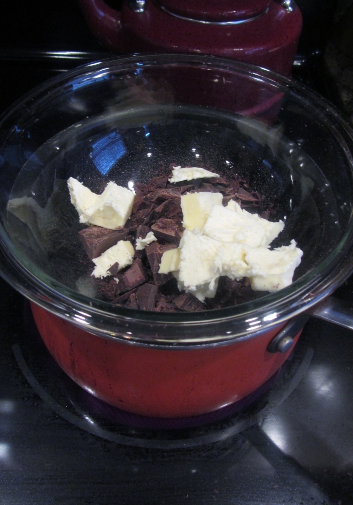 Add butter and chopped chocolate to a bowl set over a simmering pot of water. Stir occasionally.