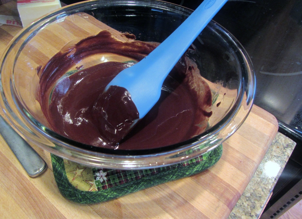 Once the butter and chocolate melt, remove from heat and set aside to cool slightly.